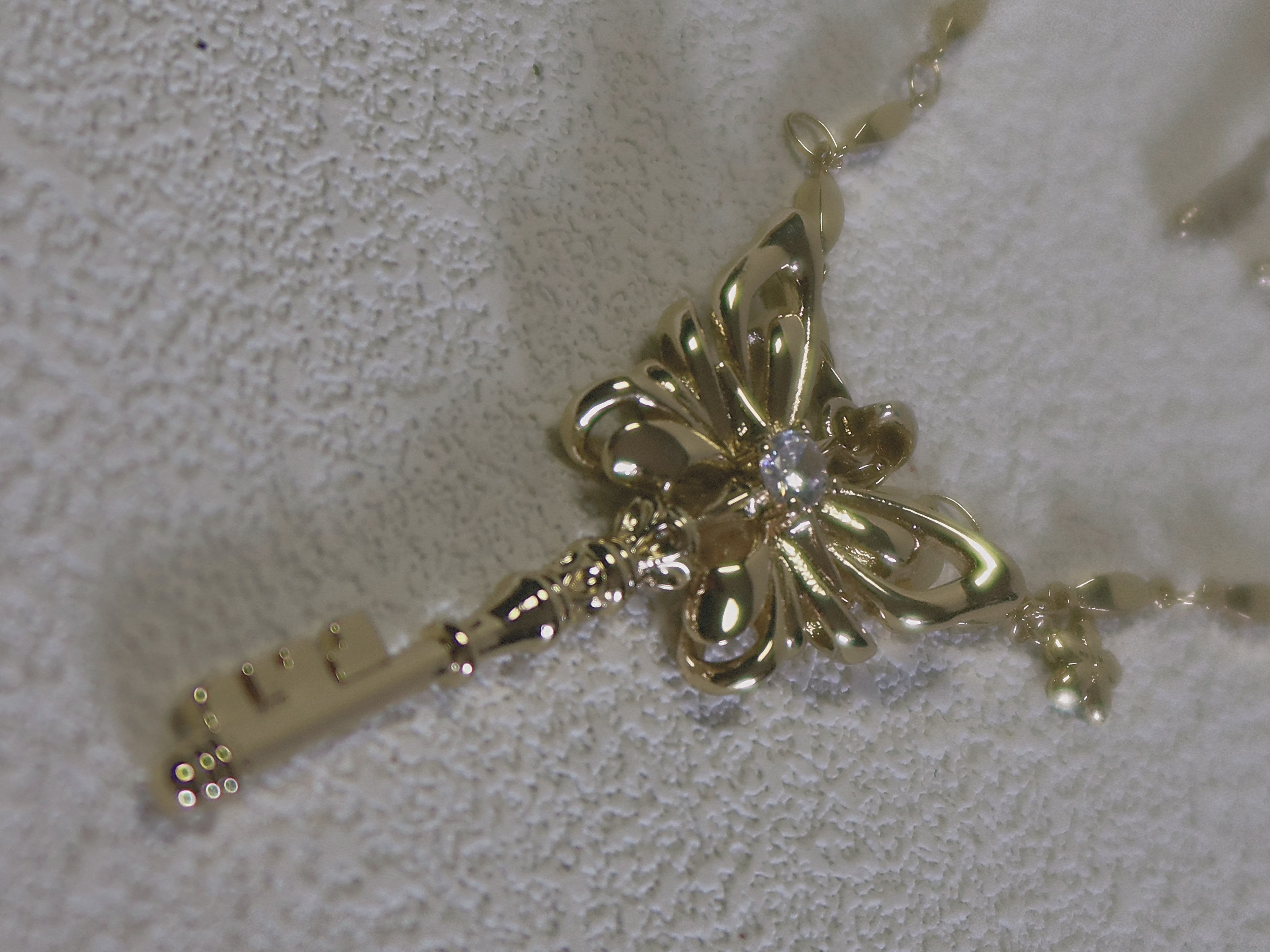 The Butterfly Key. Radiant Pendant Necklace